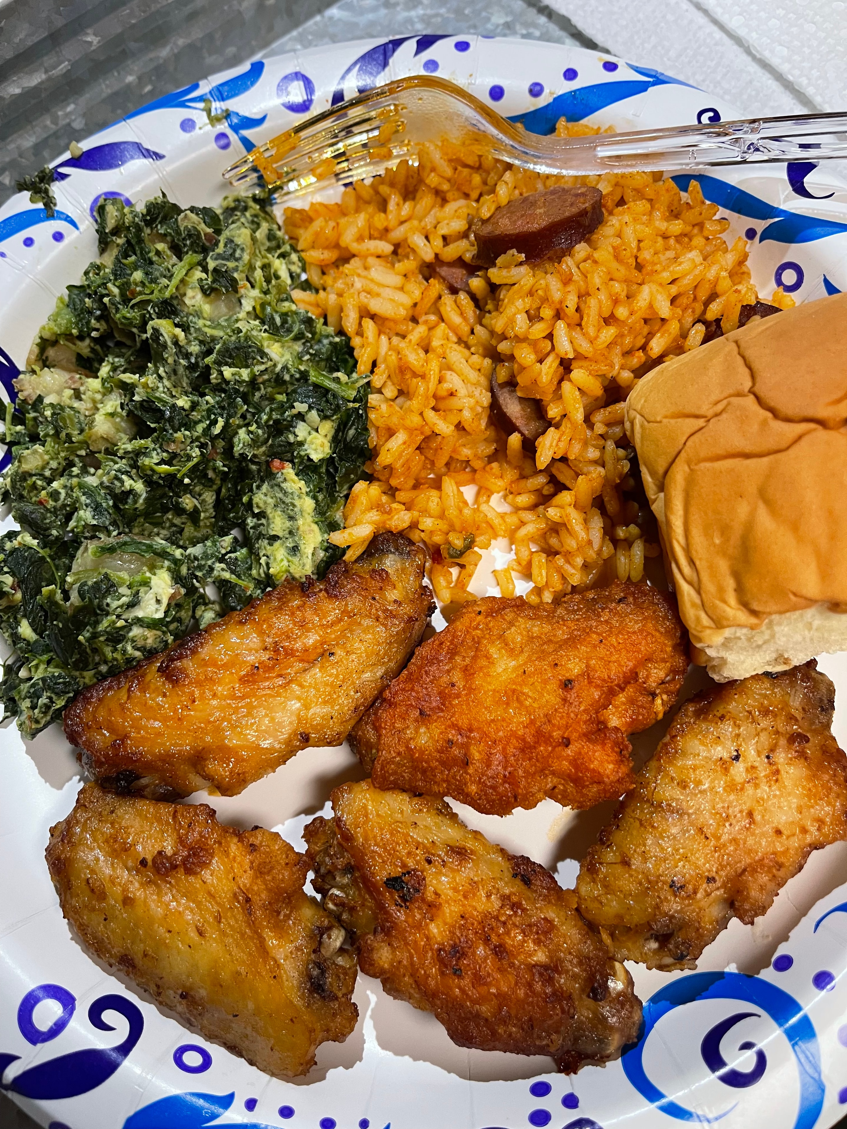 Fried chicken with jambalaya rice, spinach and a roll