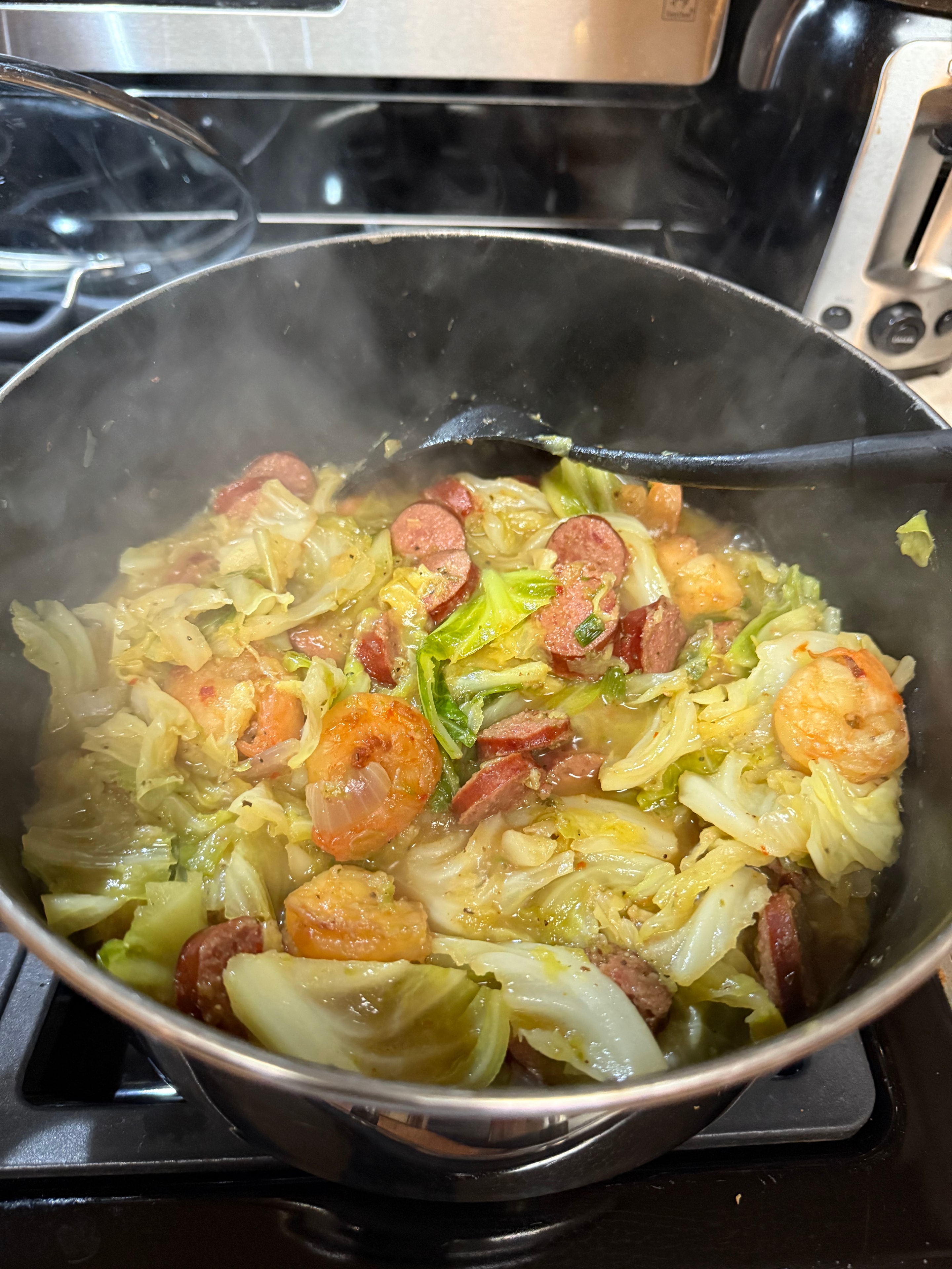 Fried cabbage with shrimp and sausage in a pot