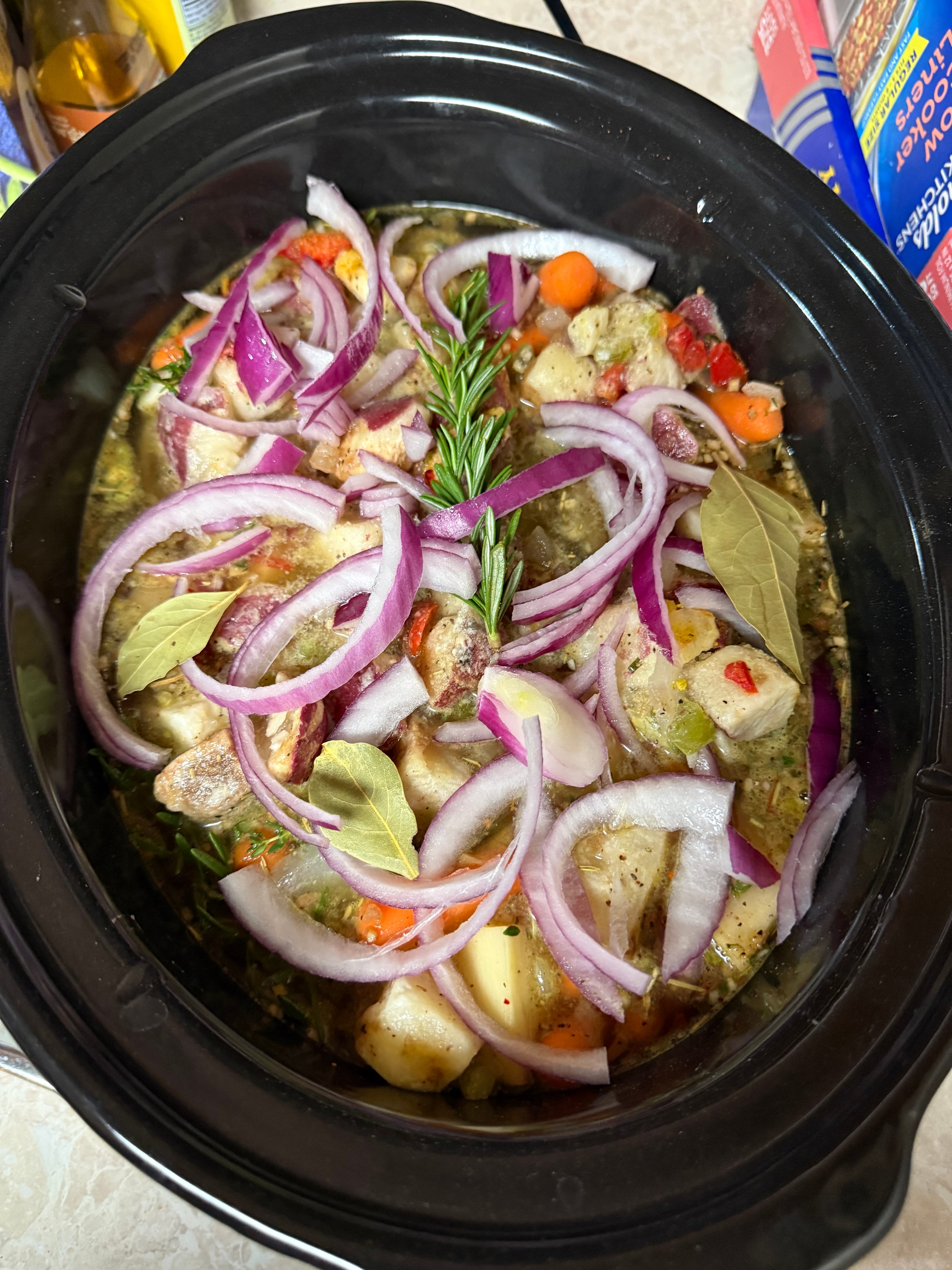 Slow cooker stew with potatoes, onions and herbs